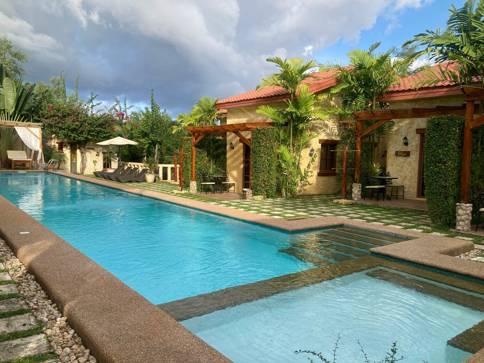 a large swimming pool surrounded by palm trees